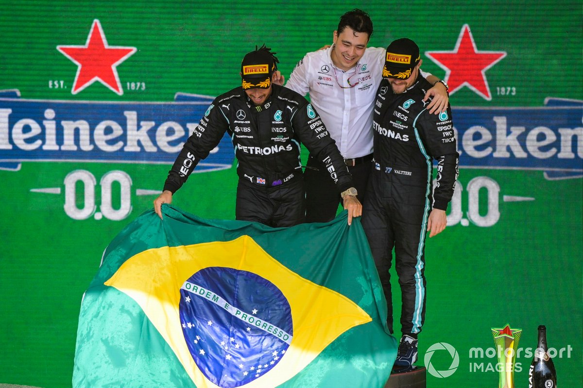 Lewis Hamilton, Mercedes, 1st position, the Mercedes trophy delegate and Valtteri Bottas, Mercedes, 3rd position, on the podium