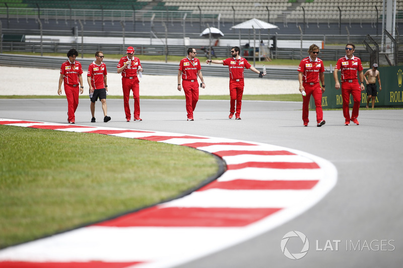 Sebastian Vettel, Ferrari, walks the track, colleagues