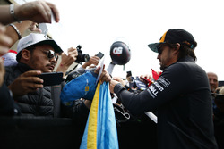 Fernando Alonso, McLaren, signs autographs for fans