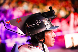 A fan with a Lewis Hamilton, Mercedes AMG F1, inspired hat