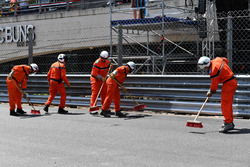 Marshals clean the track after the crash of Max Verstappen, Red Bull Racing RB14