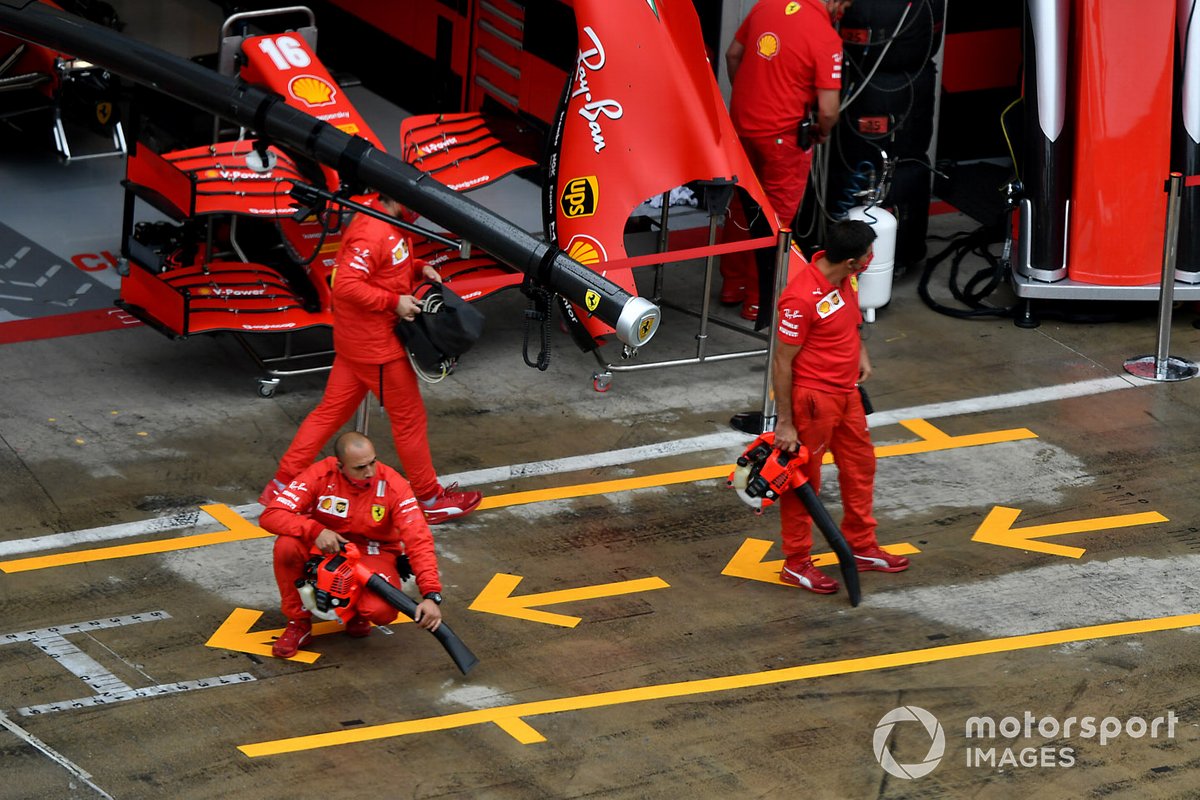 Ferrari team dry the pit lane