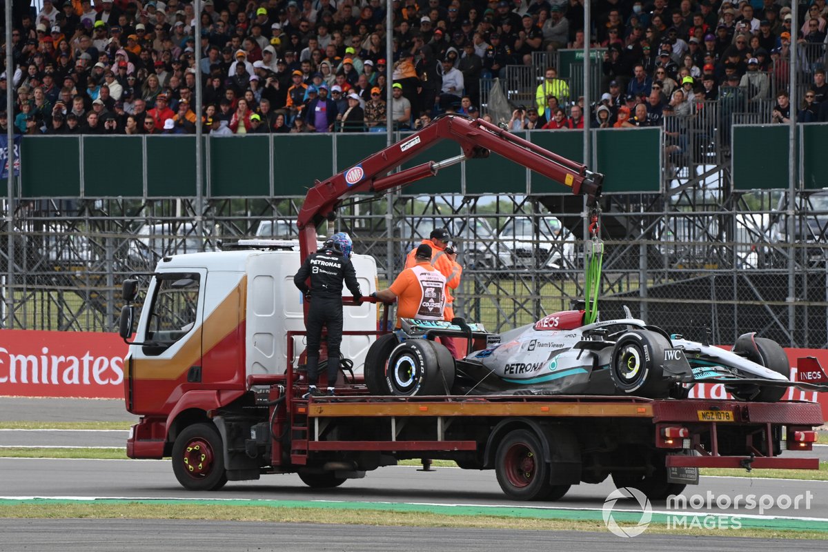 George Russell, Mercedes W13, with marshals on a truck after a crash on the opening lap