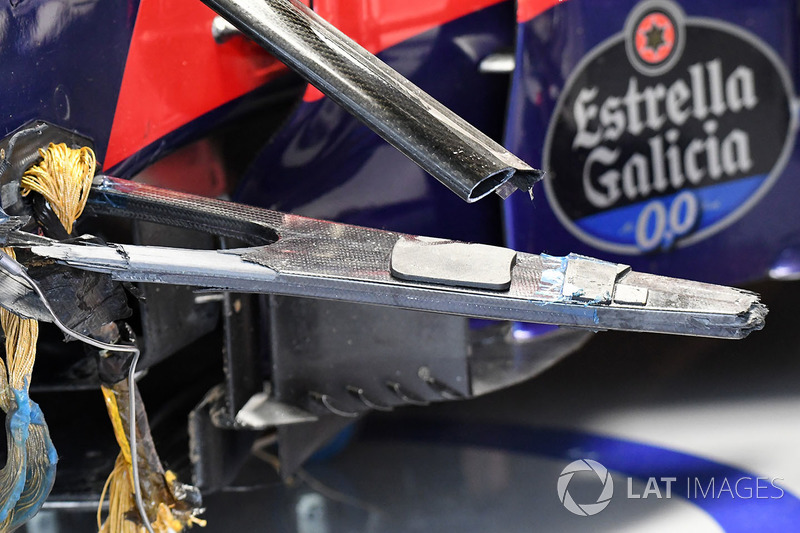 The crashed car of Carlos Sainz Jr., Scuderia Toro Rosso STR12 in the garage after FP1 shwoing broken suspension and wheel tethers