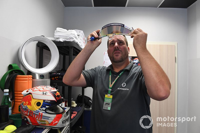 A Schuberth helmet engineer works on the helmet of Max Verstappen, Red Bull Racing