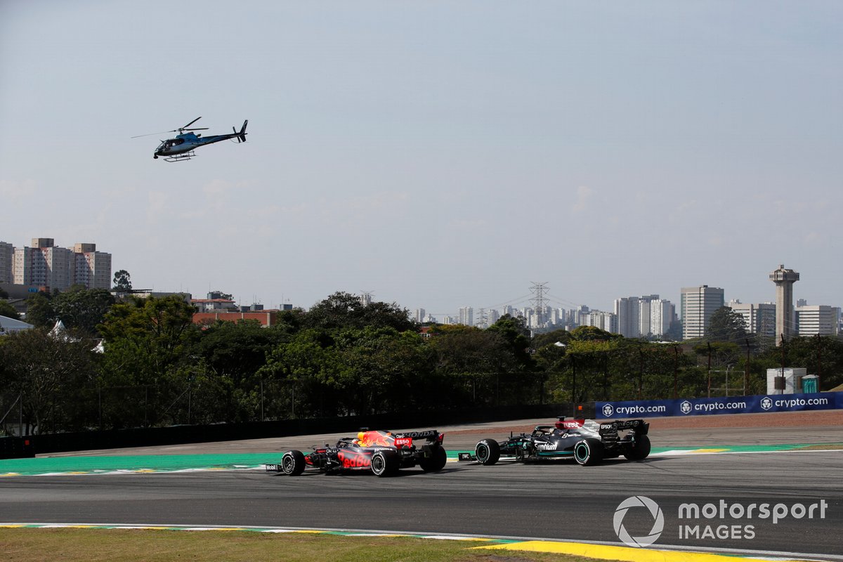 Max Verstappen, Red Bull Racing RB16B, battles with Lewis Hamilton, Mercedes W12