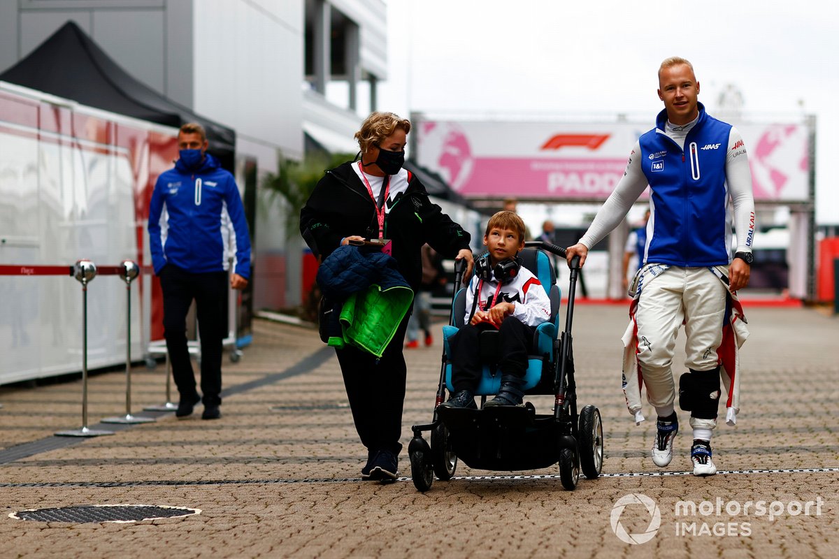 Nikita Mazepin, Haas F1, in the paddock with a young guest