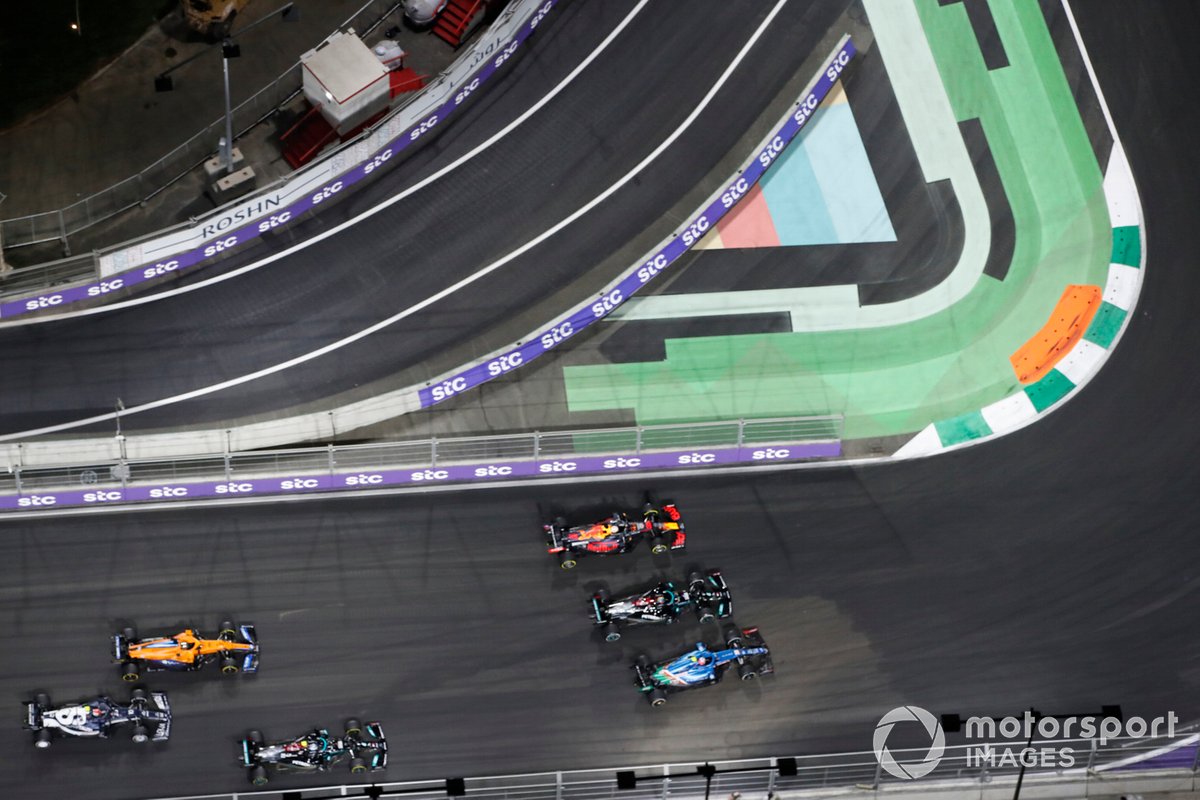 Esteban Ocon, Alpine A521, Lewis Hamilton, Mercedes W12, and Max Verstappen, Red Bull Racing RB16B, battle for the lead at the restart