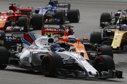Lance Stroll, Williams FW40, battles Fernando Alonso, McLaren MCL32, Sebastian Vettel, Ferrari SF70H