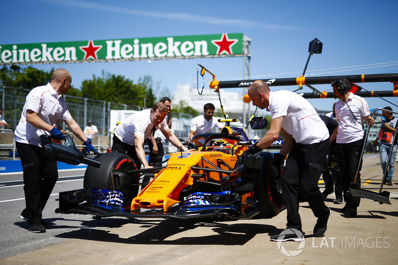 Stoffel Vandoorne, McLaren, is wheeled into his pit garage.