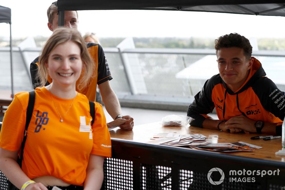 Lando Norris, McLaren signs autographs for fans.