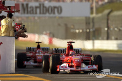 Michael Schumacher takes the checkered flag in front of Rubens Barrichello