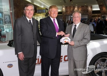 Donald Trump (C) accepts the keys to the Indianapolis 500 Chevrolet Camaro SS Convertible Pace Car from Jeff Belskus, CEO, Indianapolis Motor Speedway (L) and Jeff Chew, Marketing Manager, Chevy Racing (R), for the 100th Anniversary of the Indianapolis 50
