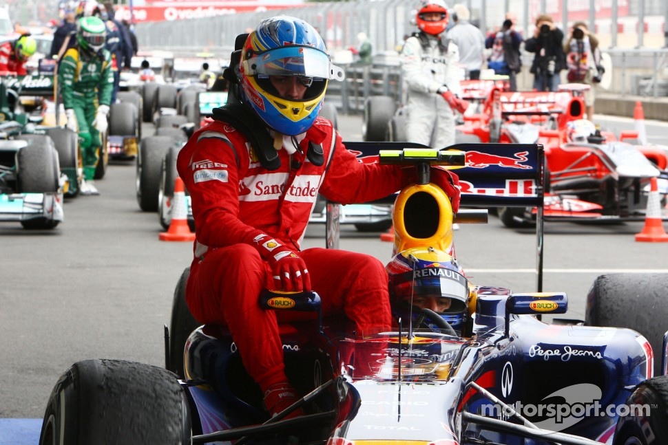 Fernando Alonso, Scuderia Ferrari has a lift back to the parc ferme with Mark Webber, Red Bull Racing