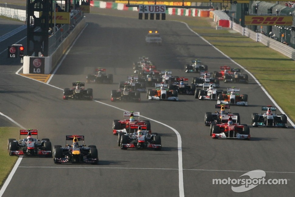 Sebastian Vettel, Red Bull Racing leads the start of the race and leads Jenson Button, McLaren Mercedes