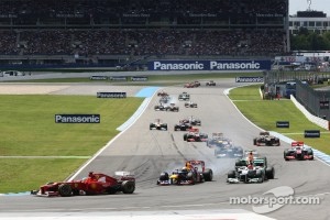 Fernando Alonso, Ferrari leads at the start of the race as Sebastian Vettel, Red Bull Racing and Michael Schumacher, Mercedes AMG F1 battle for second position