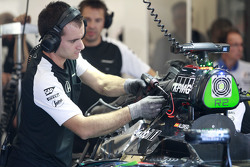 McLaren mechanics work on the McLaren MP4-30 of Fernando Alonso,