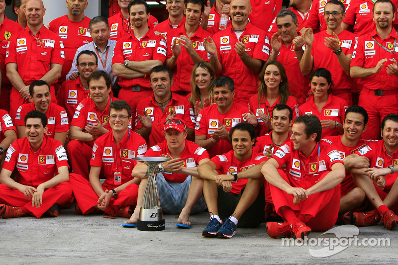 Team celebration: race winner Kimi Raikkonen celebrates with Felipe Massa and Scuderia Ferrari team