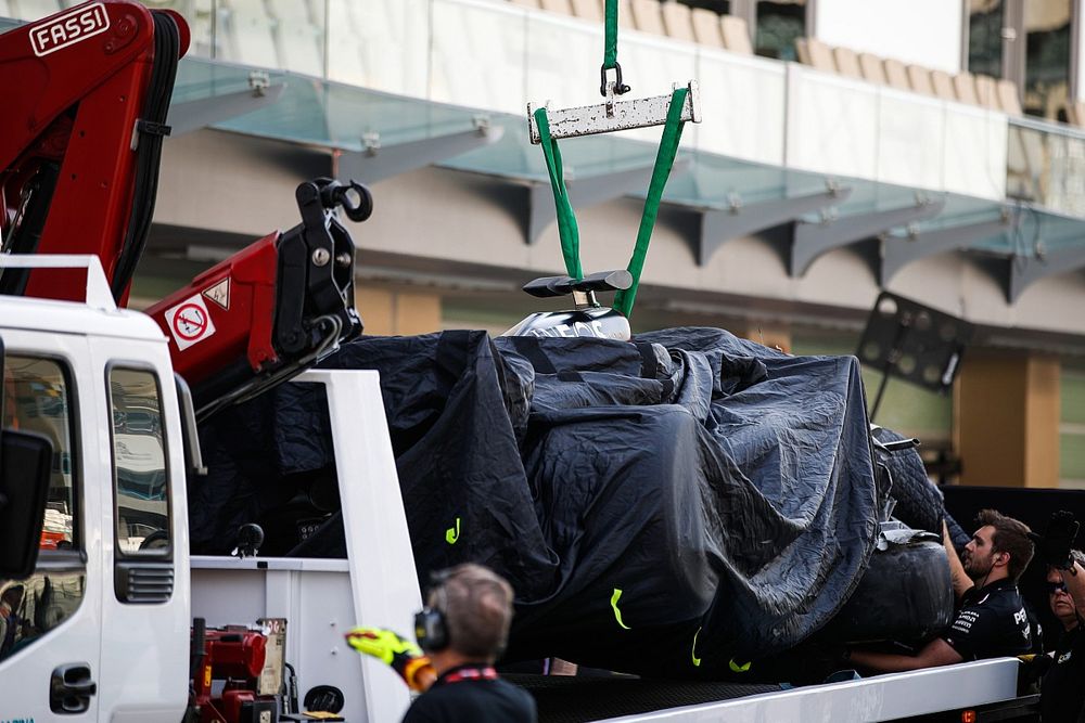 A Mercedes F1 W14 is returned to the pits on the back of a truck