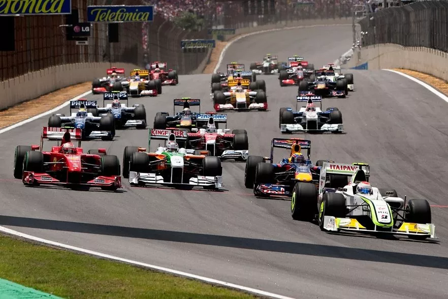 Rubens Barrichello, Brawn GP BGP001 Mercedes, 8th position, Mark Webber, Red Bull Racing RB5 Renault, 1st position, Kimi Raikkonen, Ferrari F60, 6th position, and Adrian Sutil, Force India VJM02 Mercedes, retired, lead the field through the first corner. Action. Starts.