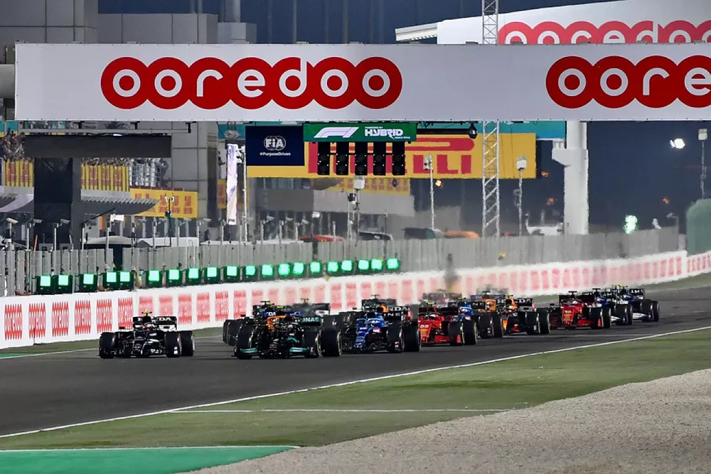 Lewis Hamilton, Mercedes W12, and Pierre Gasly, AlphaTauri AT02, lead the field away at the start