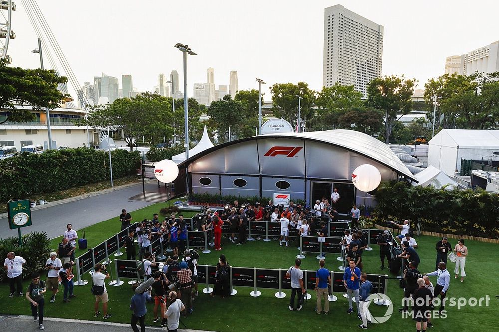 The media gather outside the F1 TV production unit for the daily drivers media session