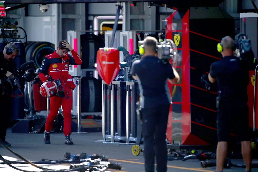 Charles Leclerc, Ferrari, walks back to his garage after retiring from the race