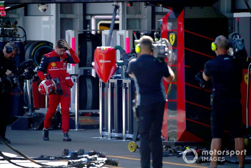 Charles Leclerc, Ferrari, walks back to his garage after retiring from the race