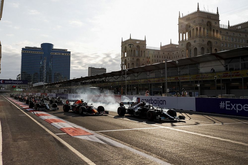 Lewis Hamilton, Mercedes W12 runs wide from Sergio Perez, Red Bull Racing RB16B at the restart of the race