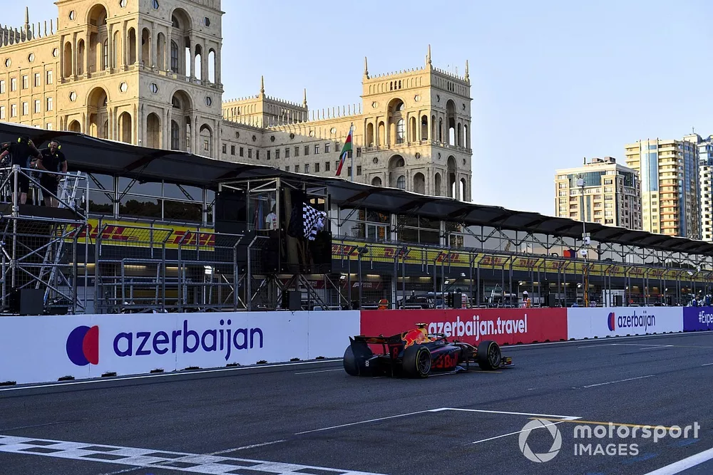 Juri Vips, Hitech Grand Prix, passes the chequered flag