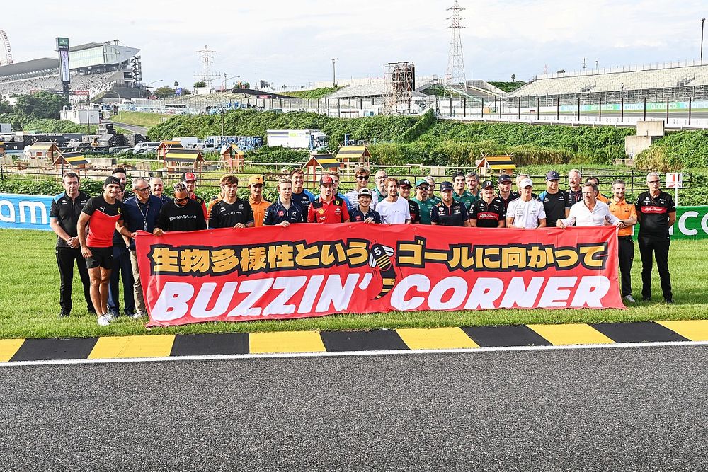 The drivers and team personnel gather with Sebastian Vettel at the Buzzin Corner