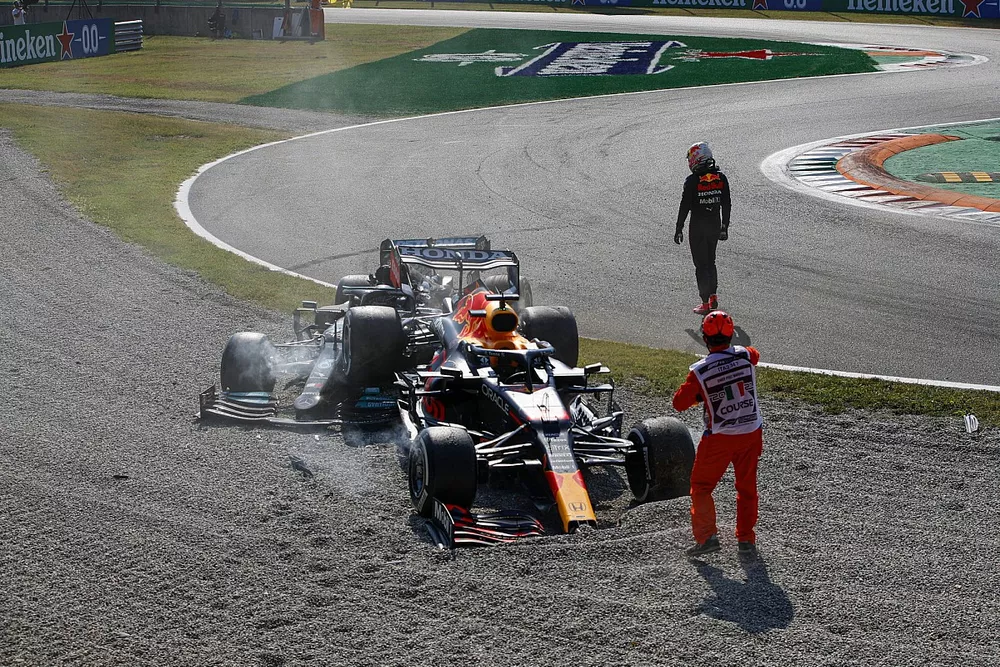 Max Verstappen, Red Bull Racing, walks away as a marshal assists at the scene of his crash with Lewis Hamilton, Mercedes W12