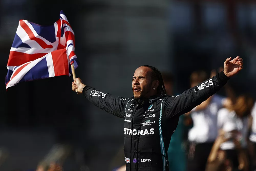 Lewis Hamilton, Mercedes, 1st position, celebrates after the race whilst parading the Union flag
