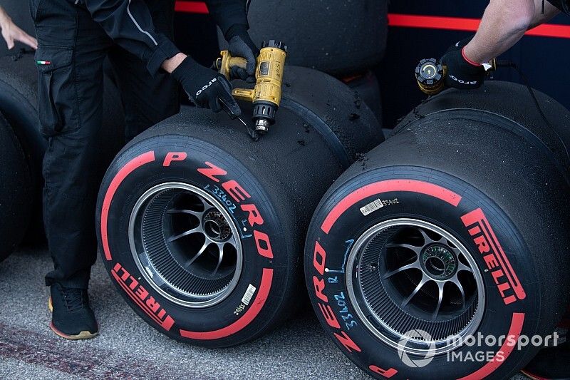 Technicians work on some tyres