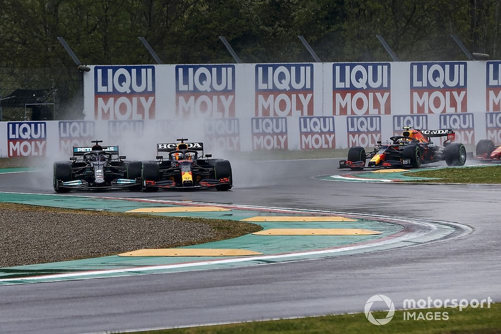 Lewis Hamilton, Mercedes W12, and Max Verstappen, Red Bull Racing RB16B, make contact on the opening lap