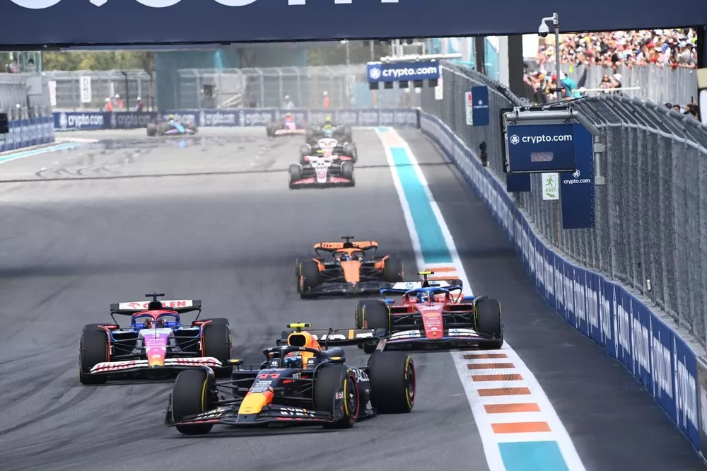 Sergio Perez, Red Bull Racing RB20, leads Daniel Ricciardo, VCARB 01, Carlos Sainz, Ferrari SF-24, and Oscar Piastri, McLaren MCL38