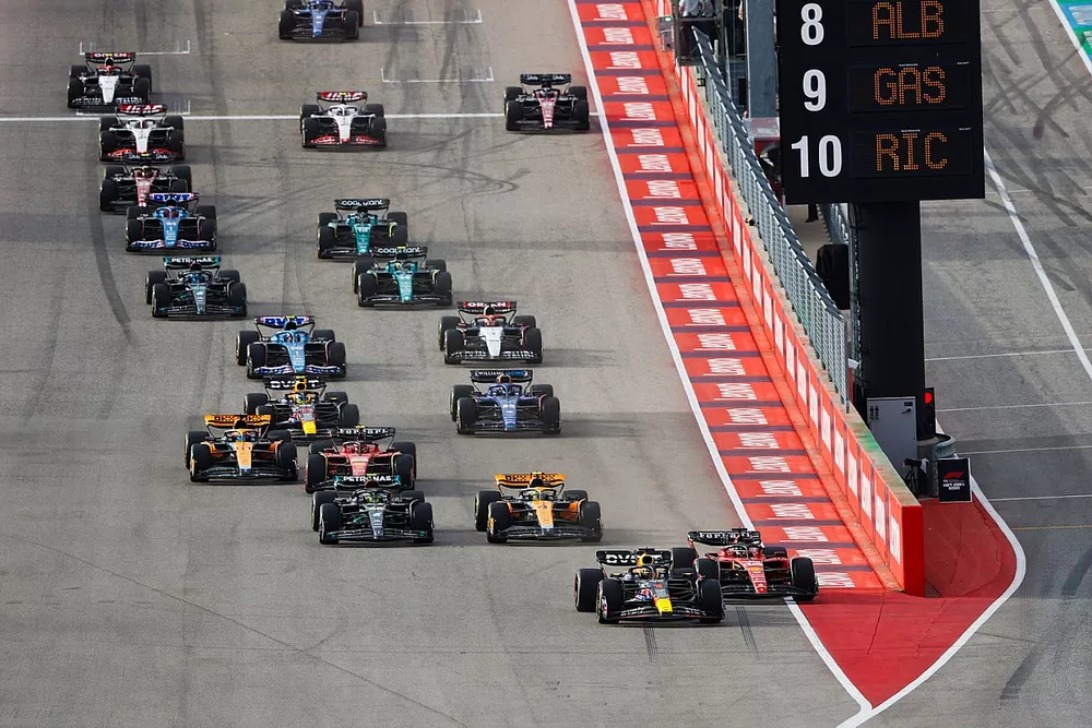 Max Verstappen, Red Bull Racing RB19, squeezes Charles Leclerc, Ferrari SF-23, ahead of Lando Norris, McLaren MCL60, Lewis Hamilton, Mercedes F1 W14, the rest of the field