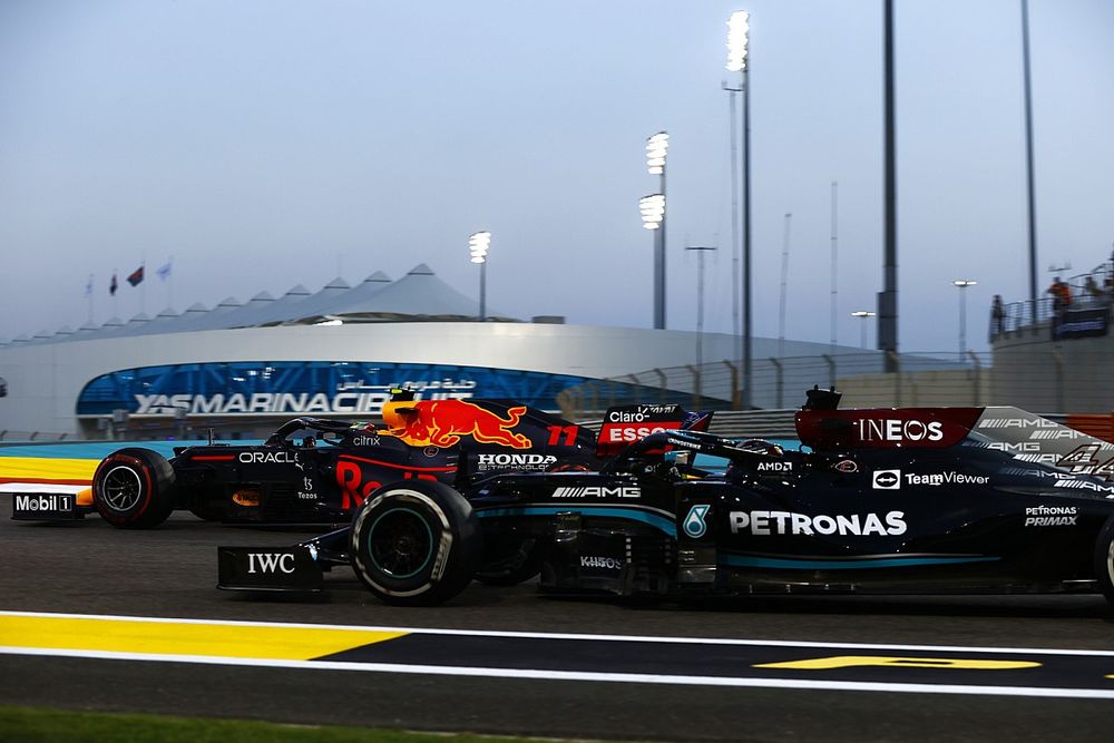 Sergio Perez, Red Bull Racing RB16B, battles with Lewis Hamilton, Mercedes W12, for the lead