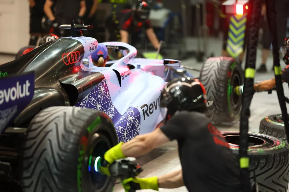 The Audi F1 Team pit crew practice a pit stop