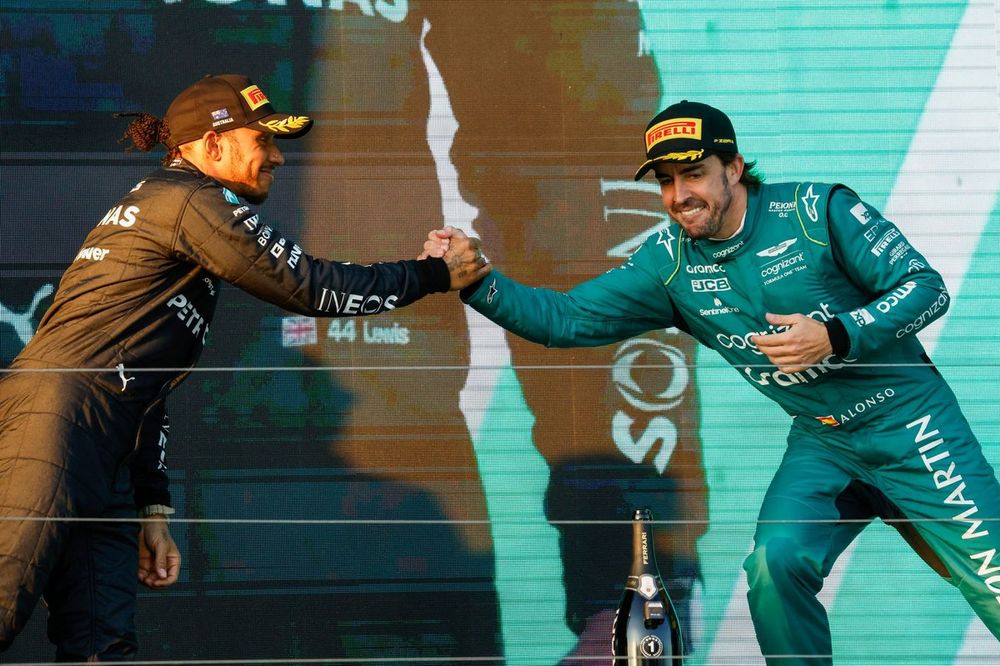 Lewis Hamilton, Mercedes-AMG, 2nd position, Fernando Alonso, Aston Martin F1 Team, 3rd position, greet each other on the podium