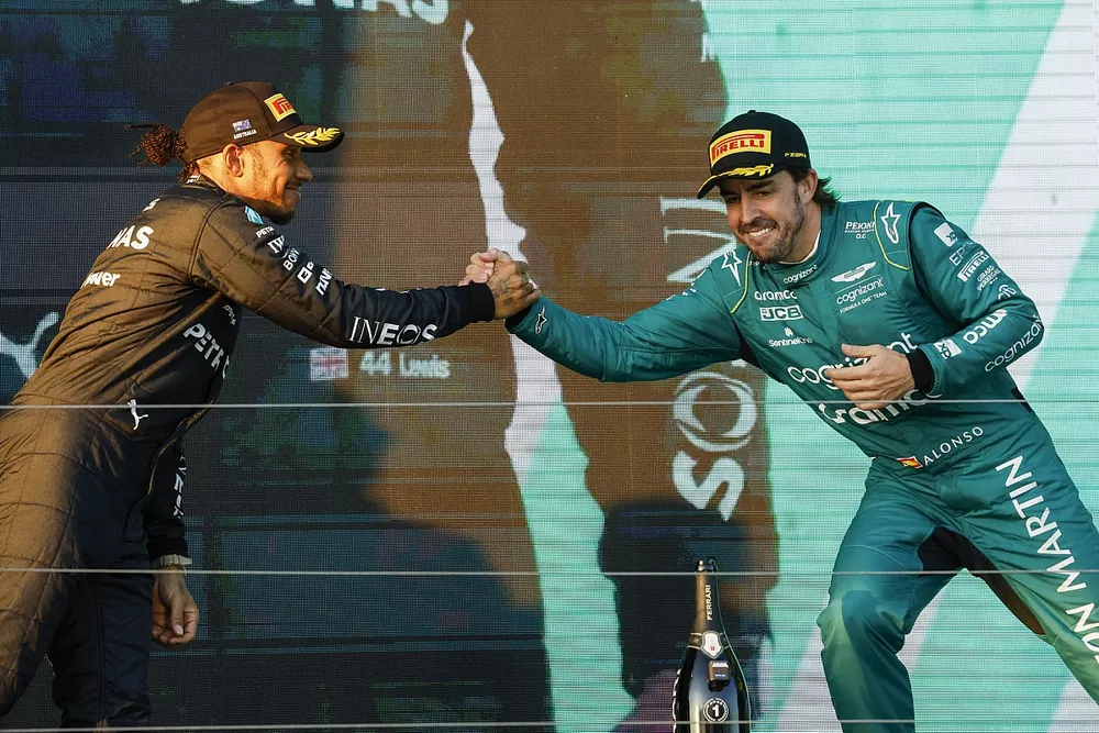 Lewis Hamilton, Mercedes-AMG, 2nd position, Fernando Alonso, Aston Martin F1 Team, 3rd position, greet each other on the podium