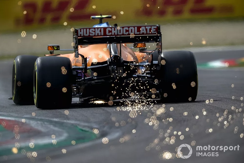 Sparks fly from the rear of Lando Norris, McLaren MCL35M