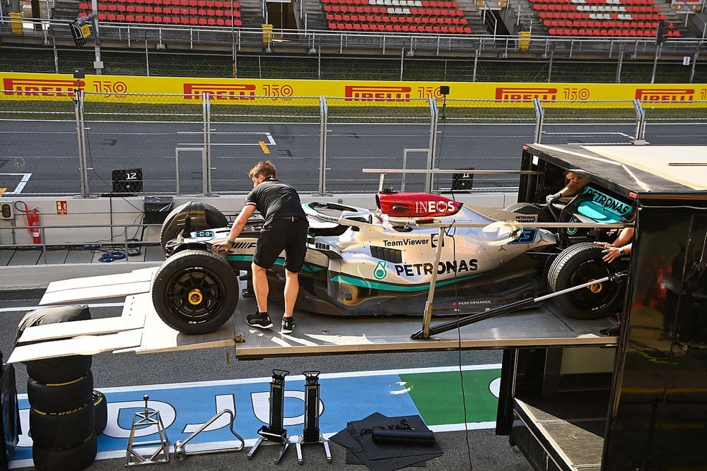 The George Russell Mercedes W13 is unloaded from a transporter