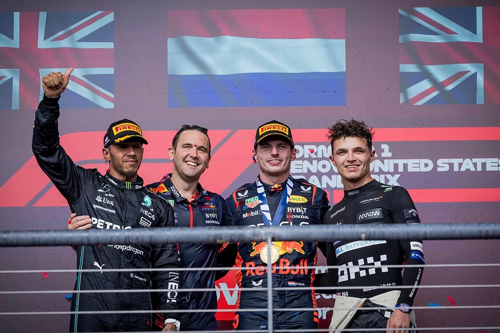 Lewis Hamilton, Mercedes-AMG, 2nd position, the Red Bull trophy delegate, Max Verstappen, Red Bull Racing, 1st position, Lando Norris, McLaren, 3rd position, on the podium
