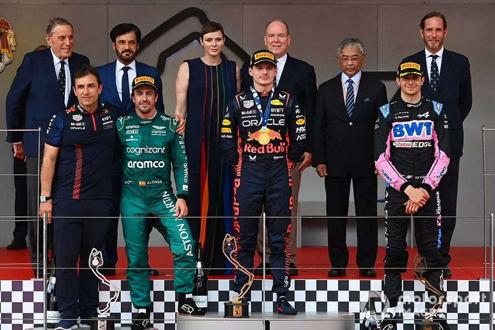 The Red Bull trophy delegate, Fernando Alonso, Aston Martin F1 Team, 2nd position, Max Verstappen, Red Bull Racing, 1st position, Esteban Ocon, Alpine F1 Team, 3rd position, on the podium
