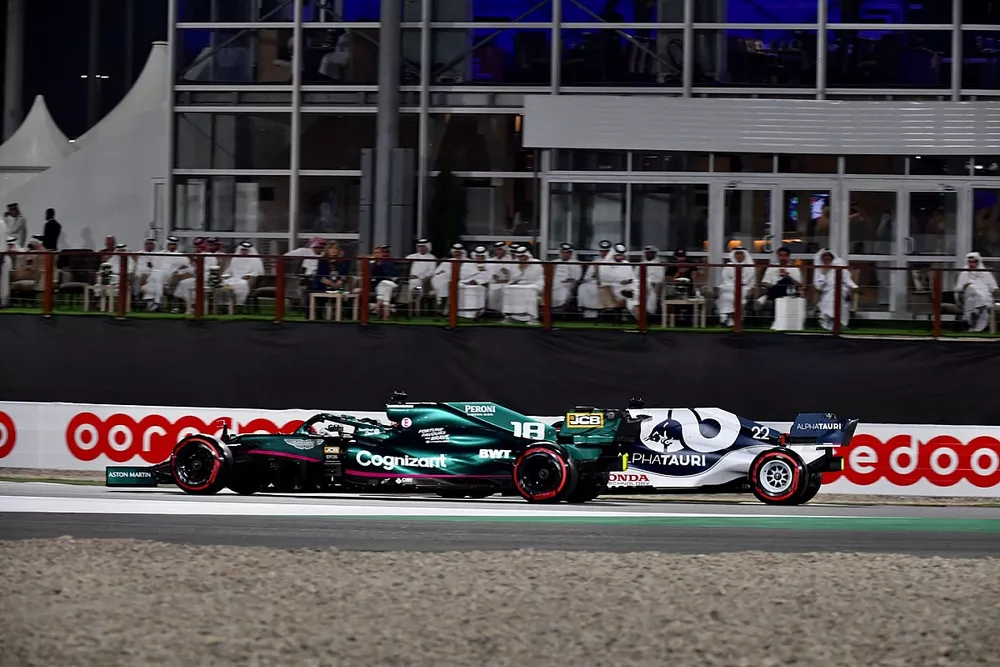 Lance Stroll, Aston Martin AMR21, passes Yuki Tsunoda, AlphaTauri AT02