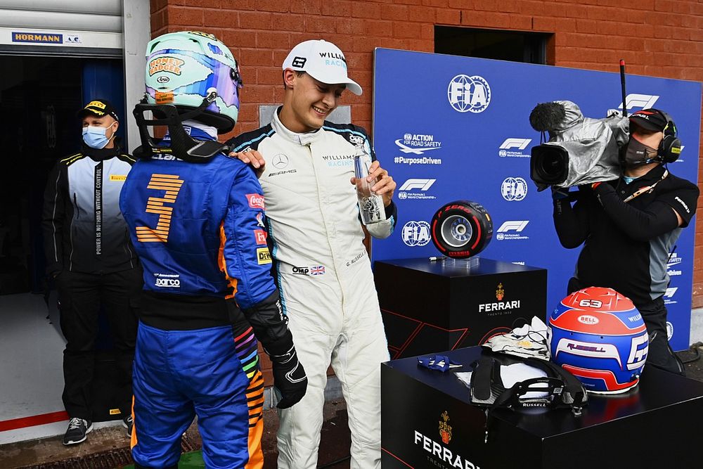 Daniel Ricciardo, McLaren, and George Russell, Williams, talk in Parc Ferme after Qualifying