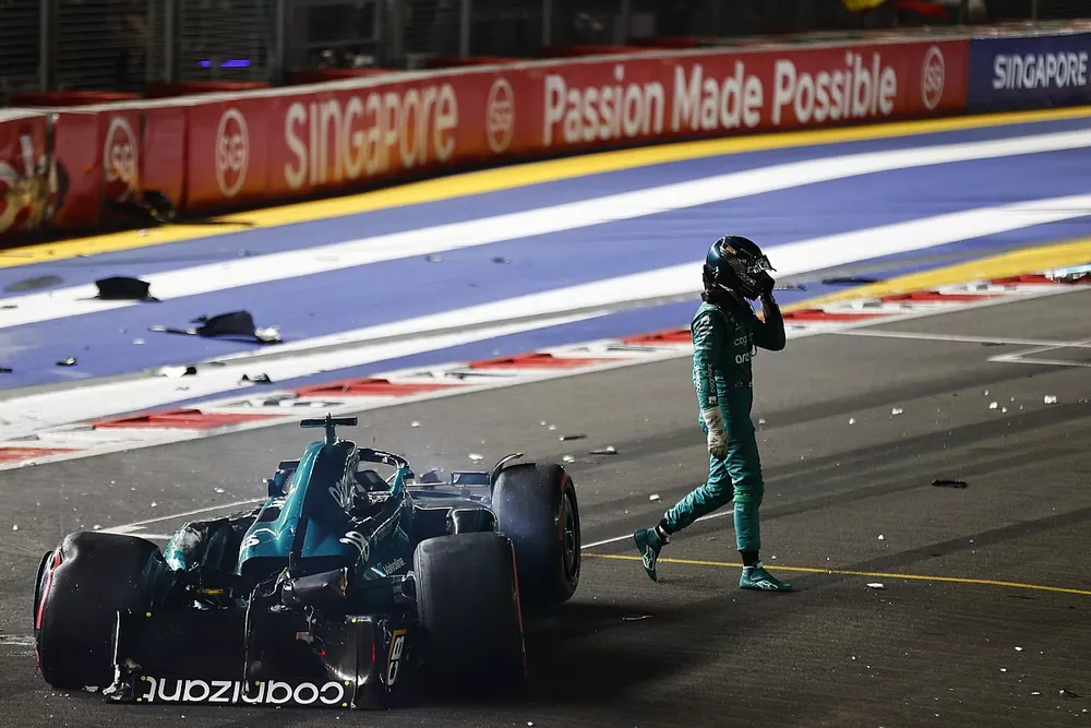 Lance Stroll, Aston Martin AMR23, walks away from his heavily damaged car after a crash towards the end of Q1