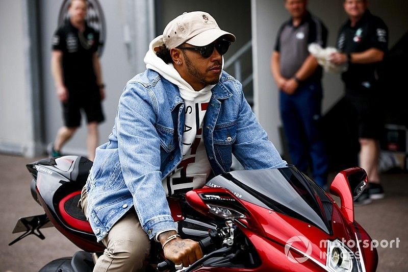 Lewis Hamilton, Mercedes AMG F1 arrives on a motorbike