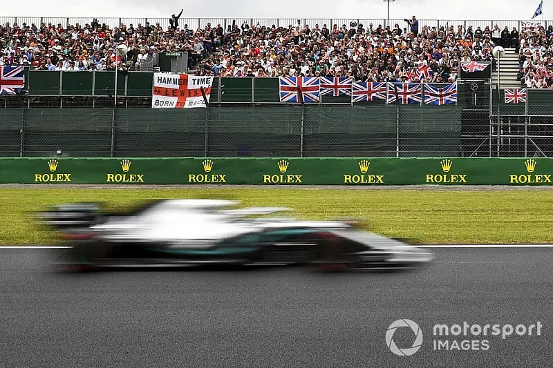 Lewis Hamilton, Mercedes AMG F1 W10, passes a grandstand full of support
